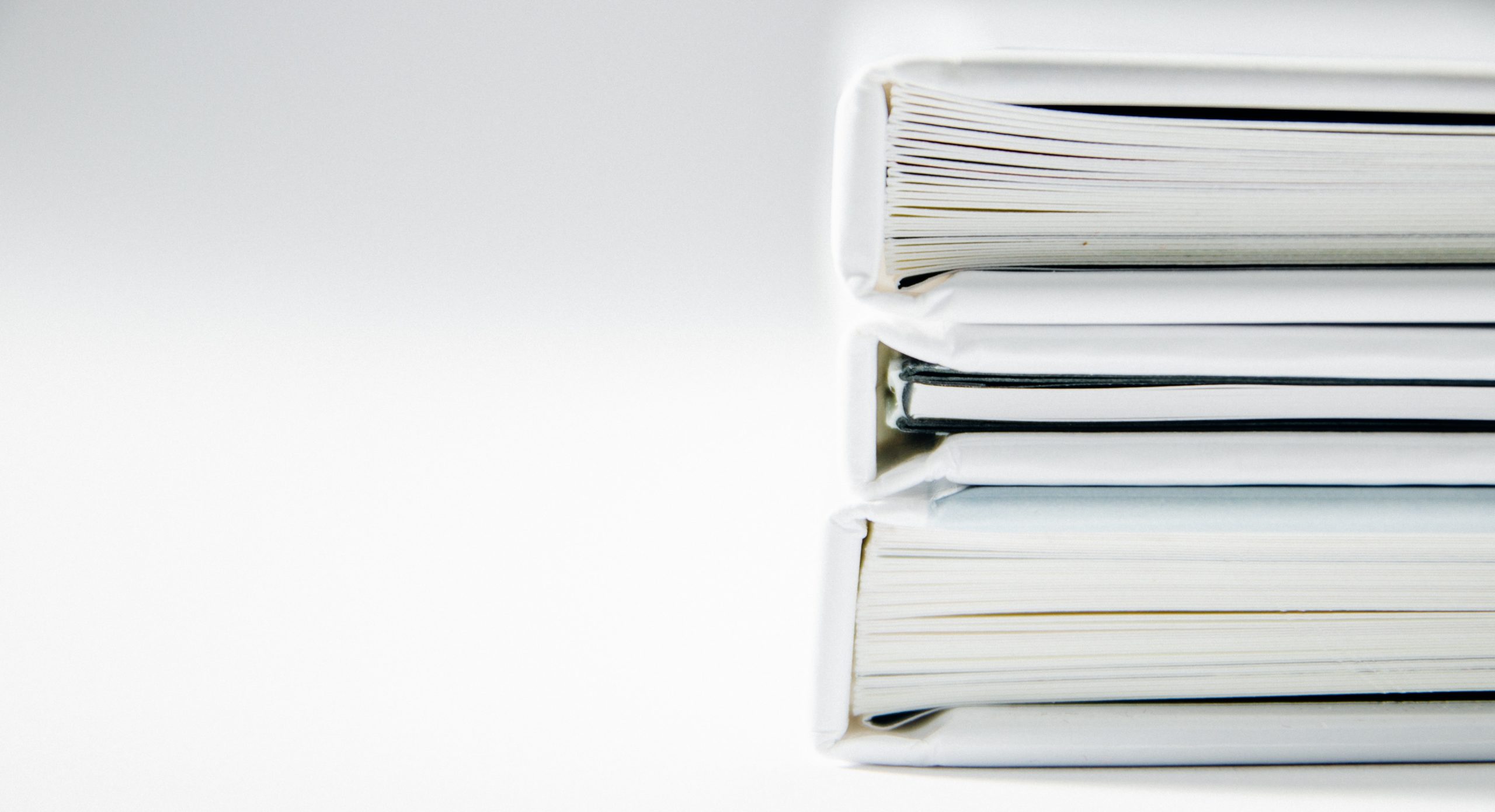 Three white binders stacked